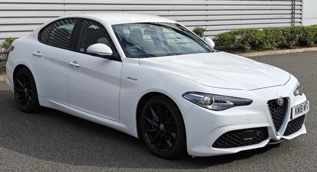 Alfa Romeo Giulia Veloce in White, front three-quarter view, showroom setting