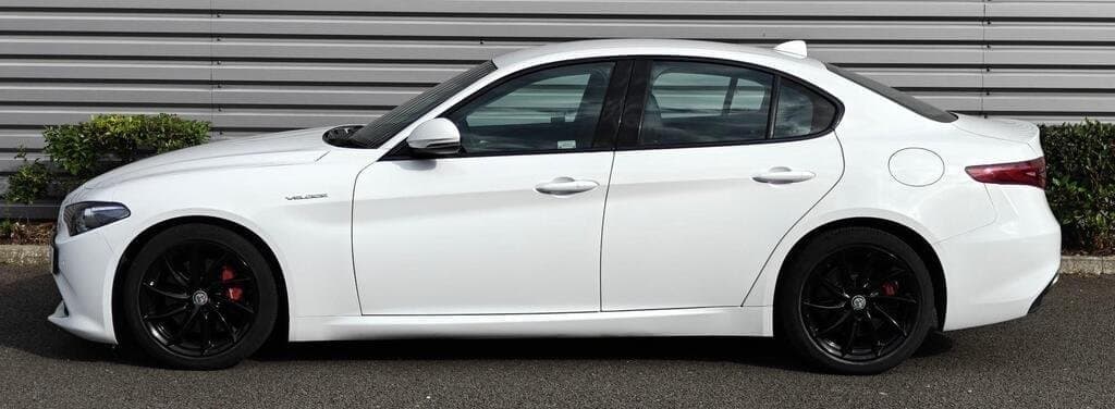 Alfa Romeo Giulia Veloce in White, side profile showing red brake calipers