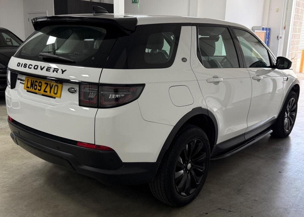 Land Rover Discovery Sport SE in Fuji White, rear three-quarter view