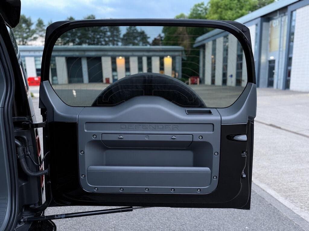 Land Rover Defender 110 tailgate interior with "DEFENDER" badge and door open