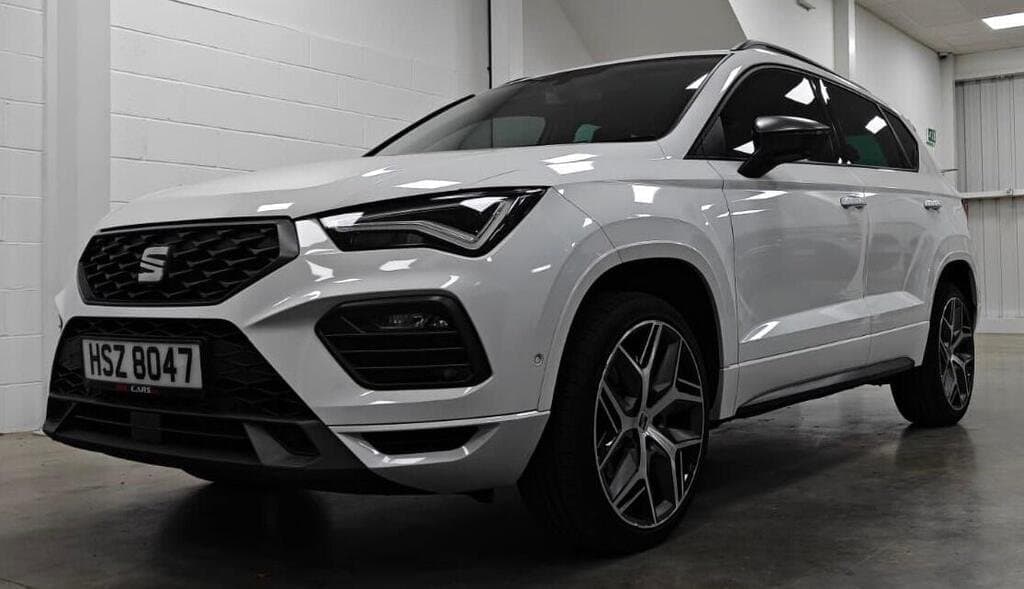 SEAT Ateca FR Sport in White, front three-quarter view, showroom setting